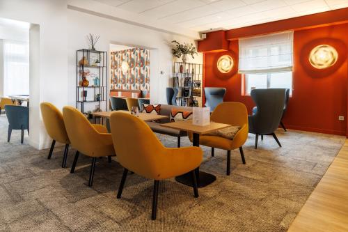 a dining room with a table and chairs at The Originals Boutique, Hôtel Le Pariou, Issoire in Issoire
