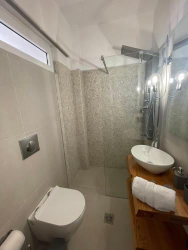 a bathroom with a toilet and a sink at Atlas Zen Blue in Loutraki