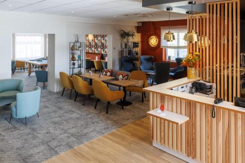 a restaurant with chairs and tables in a room at The Originals Boutique, Hôtel Le Pariou, Issoire in Issoire