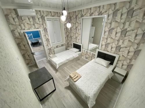an overhead view of a bedroom with two beds and a mirror at Heaven Guest House in Tashkent
