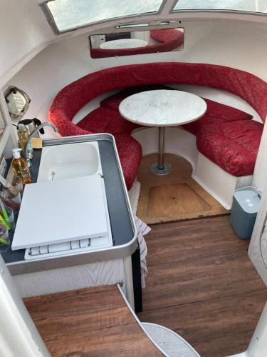- une vue depuis l'intérieur d'un salon avec une table dans l'établissement Bateau-gîte sur le halage de la Mayenne, à LʼHuisserie