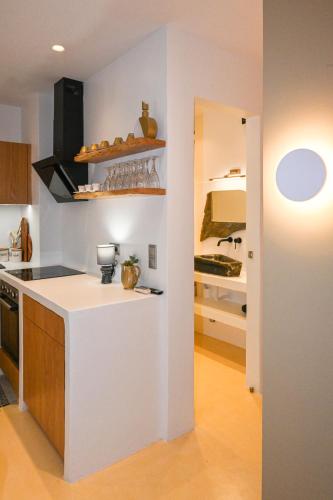 a kitchen with a white counter in a room at Alento Apartments in Tinos Town