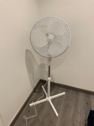 a white chair sitting on the floor next to a wall at Charmant appartement une chambre in Ville-la-Grand
