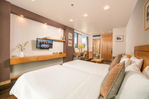 Postel nebo postele na pokoji v ubytování Parkside Sunline Hotel