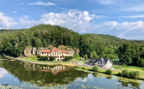 a house on a hill next to a river at Četnická Stanice Mšeno in Mšeno