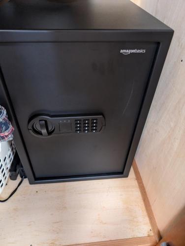a black television sitting on top of a wooden floor at private rooms in togo beach and park side house in Numazu