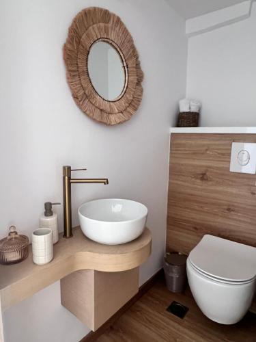 a bathroom with a sink and a mirror on the wall at Ραστώνη in Tolo