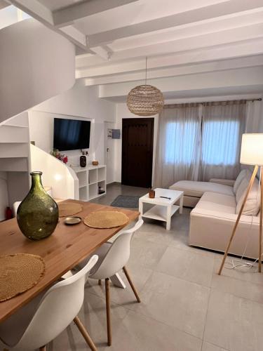 a living room with a table and a couch at Ραστώνη in Tolo