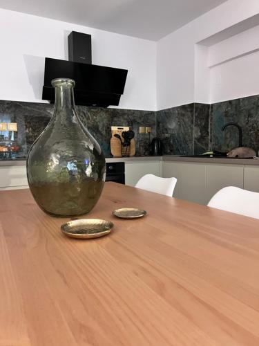 a vase sitting on a wooden table in a kitchen at Ραστώνη in Tolo
