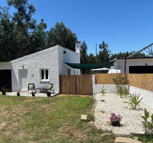 a backyard with a white house with a fence at CASA CURRAL do Porco in Tábua