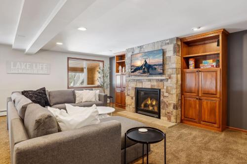a living room with a couch and a fireplace at Lakefront Getaway- Hot Tub, Firepit & Fireplaces! home in Shoreview