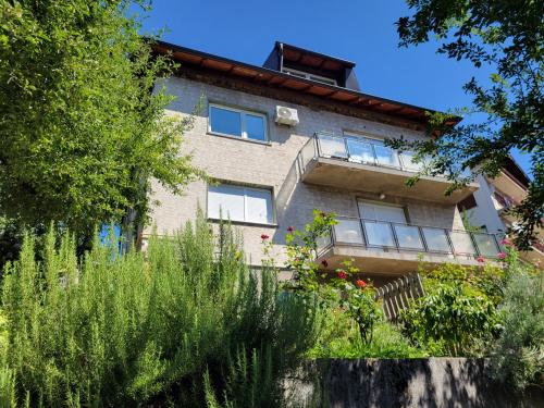 a house with a garden in front of it at Hedgehog's Home - Ježeva kućica Free Parking in Sarajevo