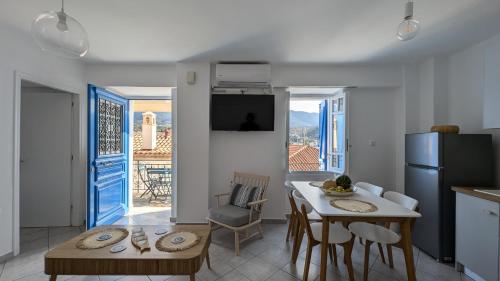 a kitchen and dining room with a table and a refrigerator at Thama Poros-Nostos in Poros