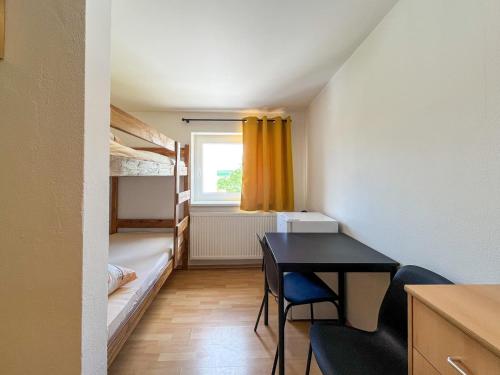 a small room with a desk and bunk beds at Penzion U Fandy in Šatov