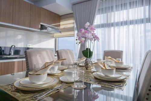 a dining room table with plates and cups on it at The Radiance Manila Bay in Manila