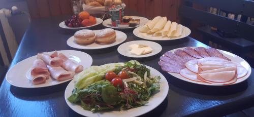 a table with plates of different types of food at Penzion U Fandy in Šatov