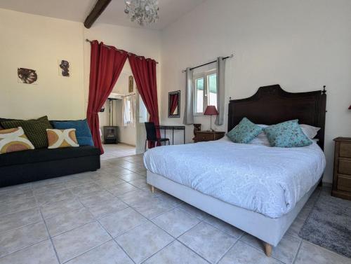 a bedroom with a large bed and a couch at CASA CURRAL do Porco in Tábua