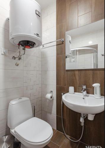 a bathroom with a toilet and a sink at Fishel in Odesa