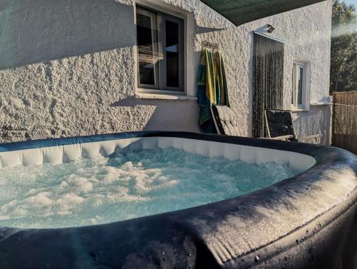 a jacuzzi tub in front of a building at CASA CURRAL do Porco in Tábua