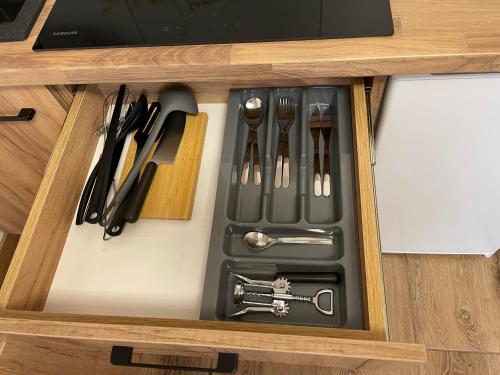a drawer filled with utensils in a cabinet at Apartamenty Zator Energy Rest in Zator