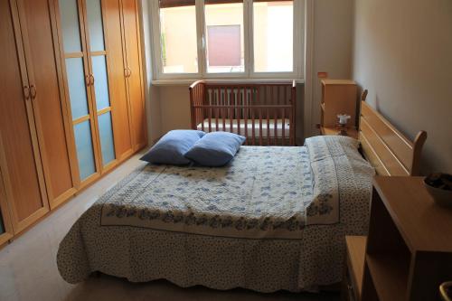 a bedroom with a bed with blue pillows on it at Monnalisa Home in Rome