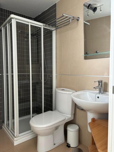 a bathroom with a toilet and a sink at Turquesa 8 in Zahara de los Atunes