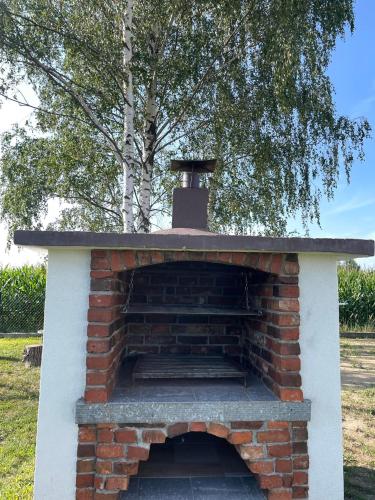 an outdoor brick oven with a roof at Apartamenty Zator Energy Rest in Zator