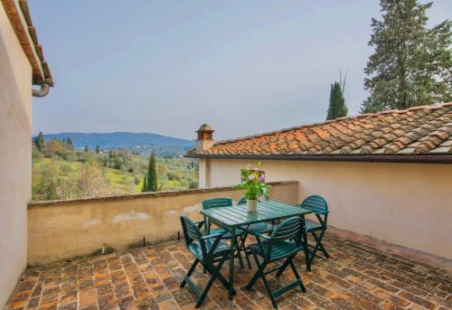 a table and chairs on a patio with a view at THR-Apartment with 3 bedrooms, 7 beds, 3 bathrooms, air conditioning and private outdoor space in a residence with swimming pool not far from Florence in Grassina