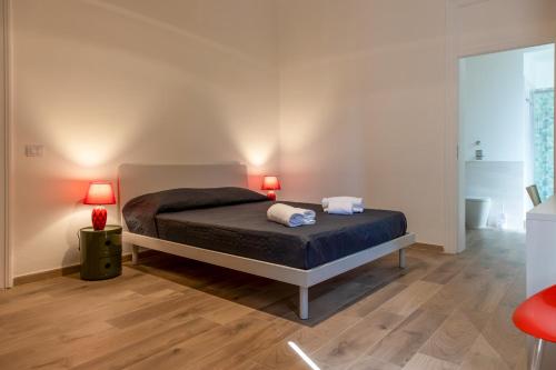 a bedroom with a bed with two lamps on it at B&B Il Sole Blu in Trapani