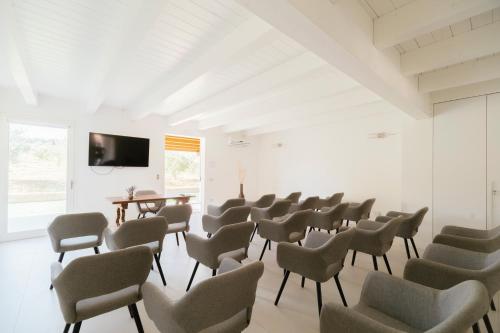 a room with chairs and a flat screen tv at Agriturismo Il Colle Dei Lecci in Ancona