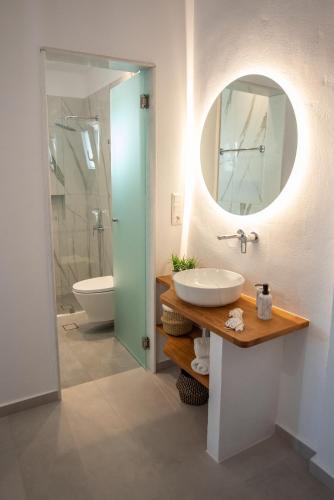a bathroom with a sink and a mirror at Panoramic View in Agios Prokopios