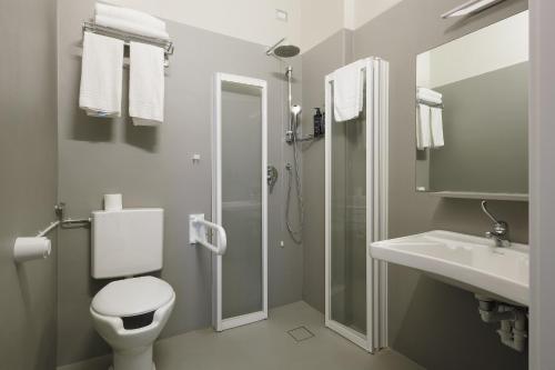 a bathroom with a shower and a toilet and a sink at Hotel 22 Marzo in Milan