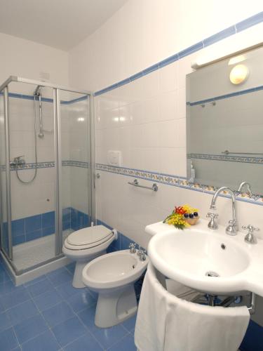 a bathroom with a toilet and a sink and a shower at Aurora Residence in Amalfi