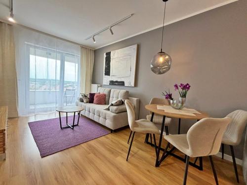 a living room with a couch and a table at Sun Towers - Apartamenty Bryza - Apartamenty z parkingiem in Świnoujście