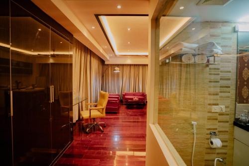 a hotel room with a waiting area and a room with at Royal Residence Dhaka in Dhaka