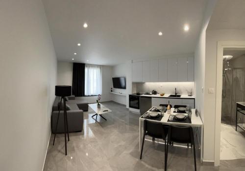 a kitchen and living room with a table and chairs at Eleva Deluxe in Kastoria