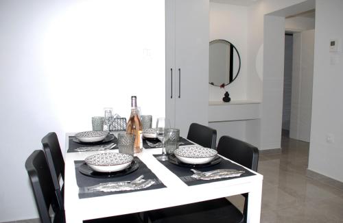 a dining room table with a white table and chairs at Eleva Deluxe in Kastoria