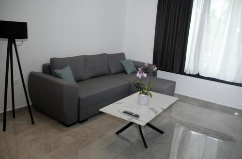 a living room with a couch and a coffee table at Eleva Deluxe in Kastoria