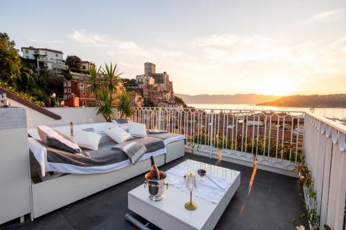 a balcony with a bed and a view of the water at Torretta San Rocco -Luxury Suite in Lerici