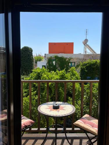 a table on a balcony with a view of a city at Mirodaty's House in Rhodes Town