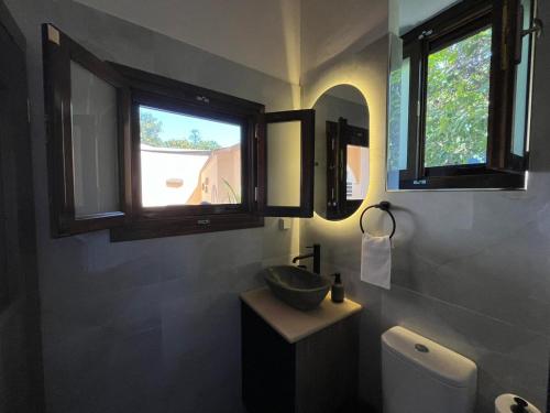 a bathroom with a sink and two windows at Mirodaty's House in Rhodes Town