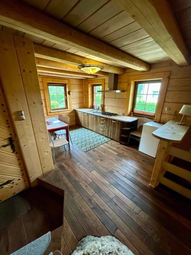 an inside view of a cabin with a table and chairs at Domek w skale in Kroczyce