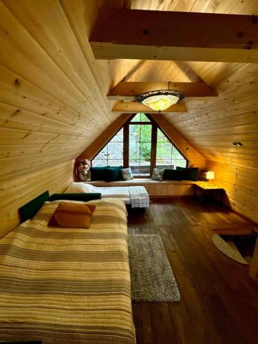 a large room with a bed and a large window at Domek w skale in Kroczyce