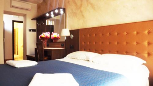 a bedroom with a large bed with a large headboard at Hotel Nautilus in Rome