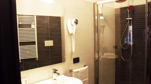 a bathroom with a shower and a phone on the wall at Hotel Nautilus in Rome