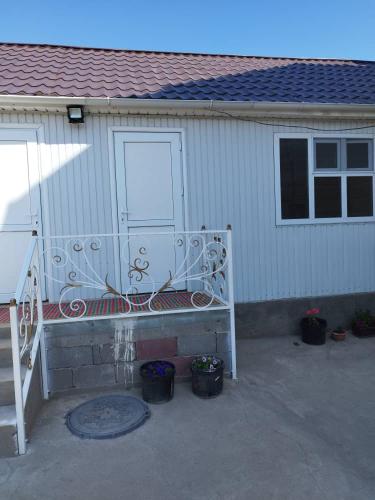 a bench sitting in front of a building at Уют in Tong