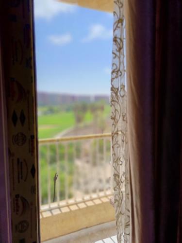an open window with a view of a field at بورتو جولف مارينا Porto Golf Marina in El Alamein