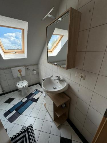 a bathroom with a sink and a toilet at Ferienwohnung Lias in Südbrookmerland