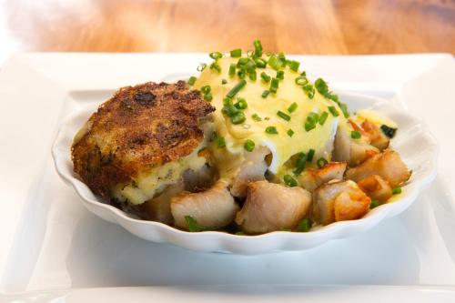 a white bowl of food with meat and potatoes at Sharamore House B&B in Clifden