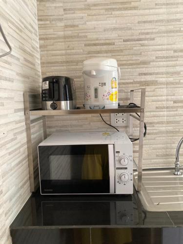 a microwave sitting on a counter in a kitchen at T&P at Pai in Pai